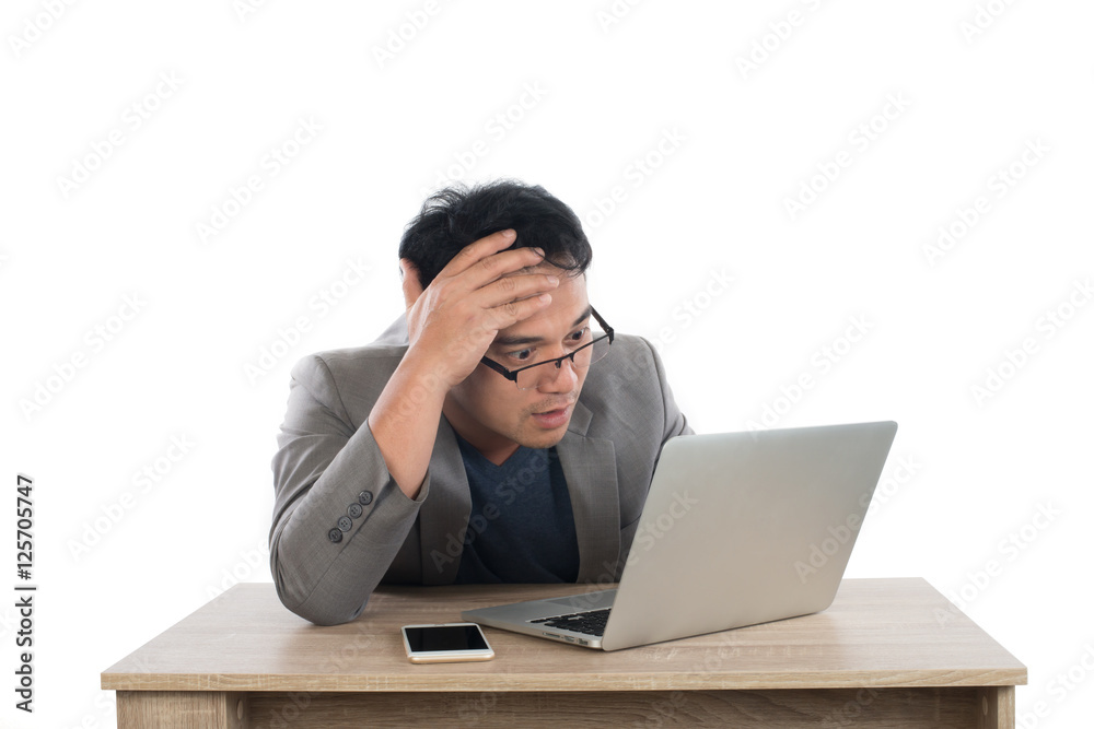 Stressed businessman work with laptop sitting at table isolated Stressed businessman work with laptop sitting at table isolated