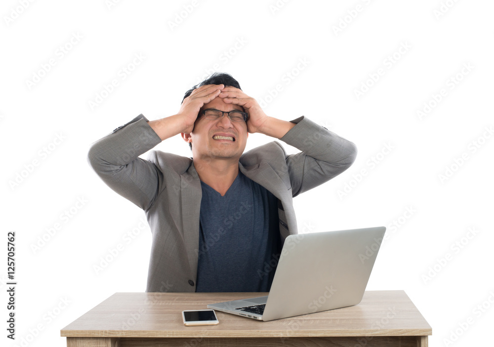 Stressed businessman work with laptop sitting at table isolated Stressed businessman work with laptop sitting at table isolated