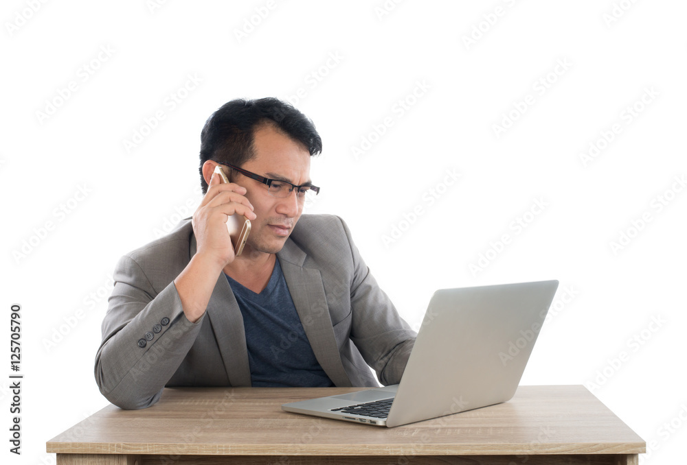 Stressed businessman talking on phone work with laptop sitting Stressed businessman talking on phone work with laptop sitting