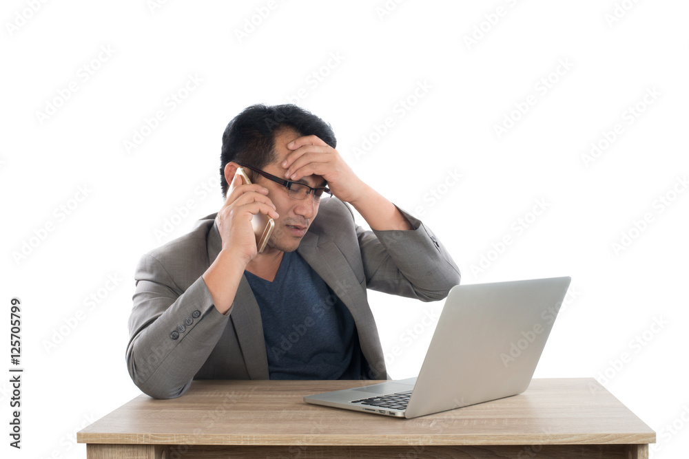 Stressed businessman talking on phone work with laptop sitting Stressed businessman talking on phone work with laptop sitting