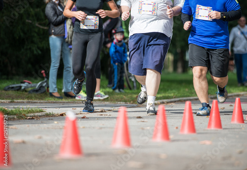 Group of unrecognizable runners outdoors. Long distance running.