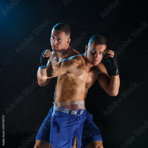 Male boxer boxing in a dark studio © master1305