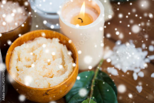 natural body scrub and candle on wood