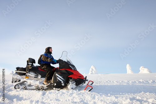 Man driving snowmobile in Finland