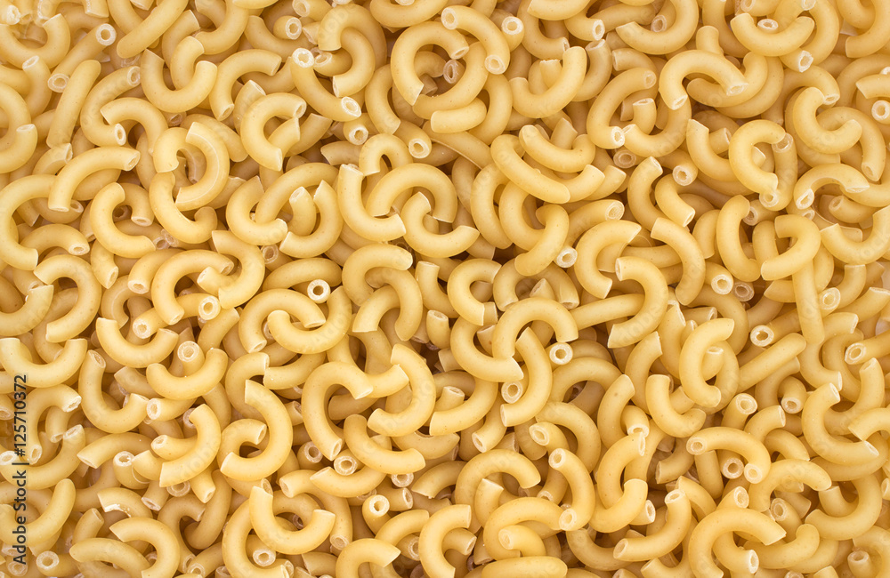 Uncooked elbow pasta background Uncooked elbow pasta background