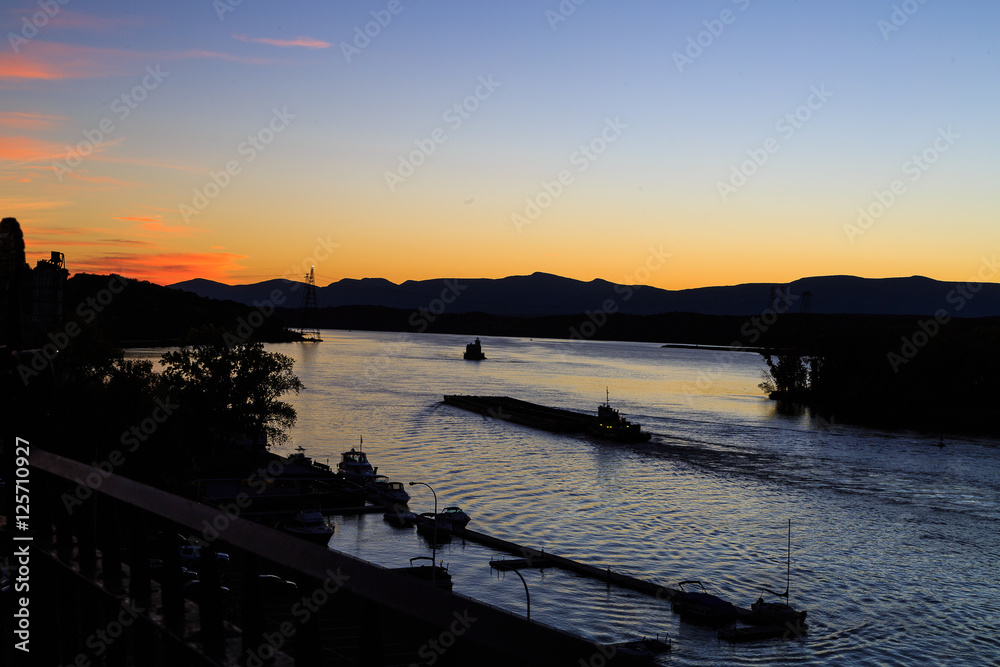 Hudson River at dusk in Hudson with lighthouse and boats