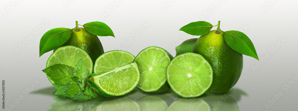 Sliced and whole limes in a panoramic
