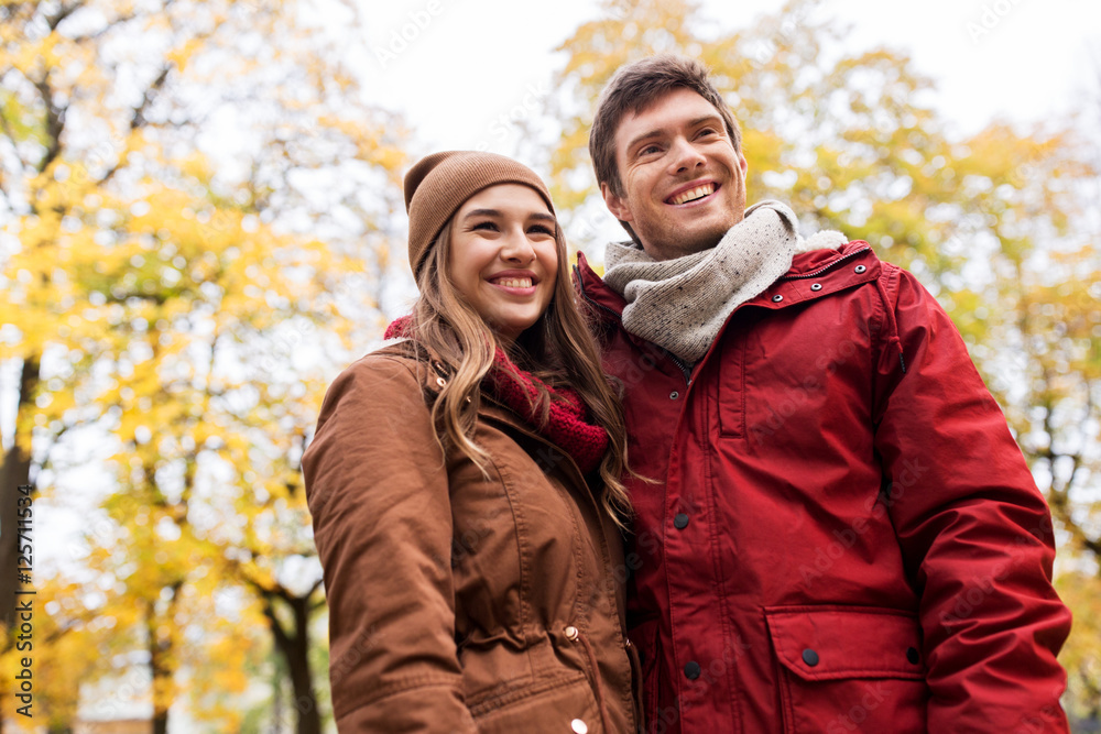 Fototapeta premium happy young couple walking in autumn park