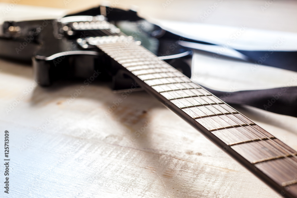 Fototapeta premium Electric guitar on old wooden surface