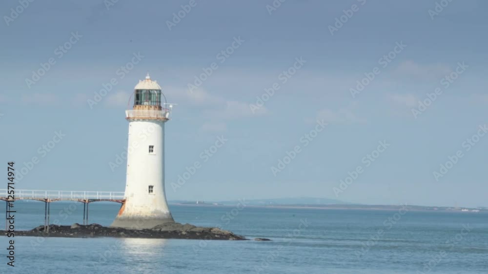 White small lighthouse in the river in Killimer Ireland. It is located on the northern bank of the Shannon and the N67 which passes through the village. White small lighthouse in the river in Killimer Ireland. It is located on the northern bank of the Shannon and the N67 which passes through the village.