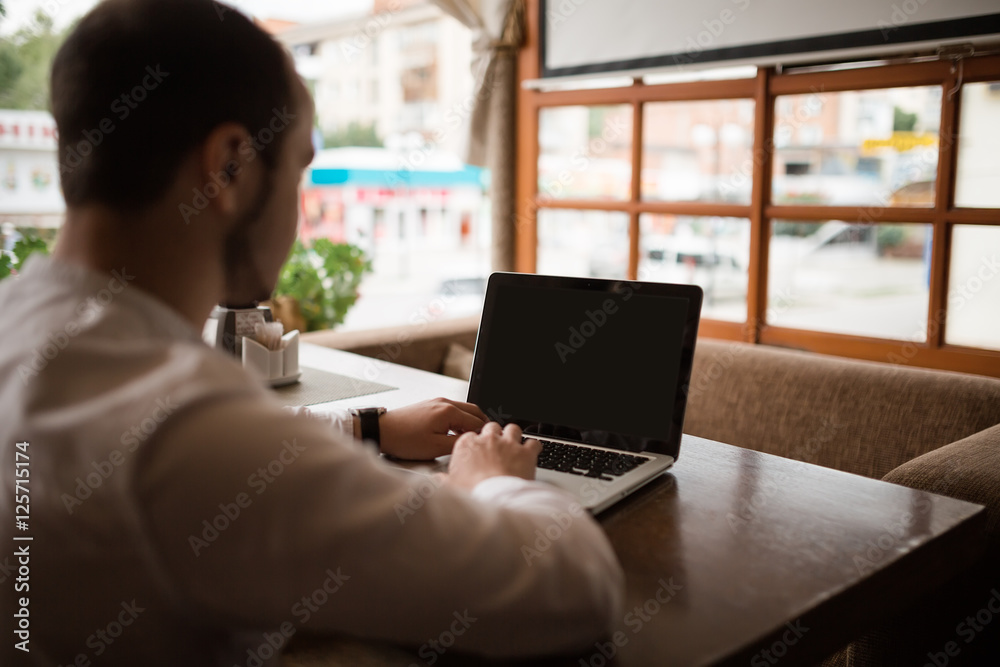 Man is looking at laptop with excitement. Man is looking at laptop with excitement.