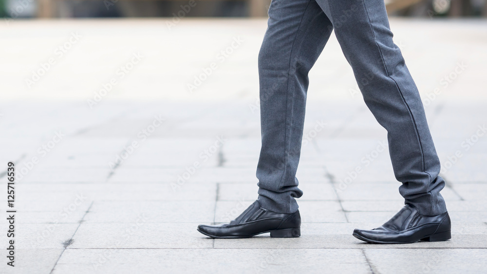Businessman crossing the street on crosswalk Businessman crossing the street on crosswalk