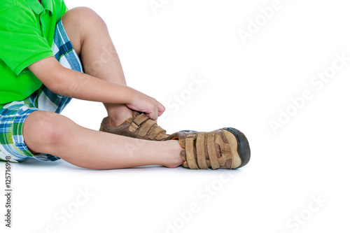 Slika na platnu Side view of child put leather shoes on