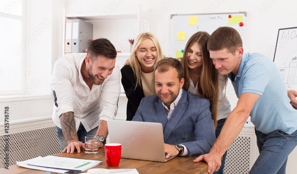 Fototapeta premium Happy business people team together look at laptop in office