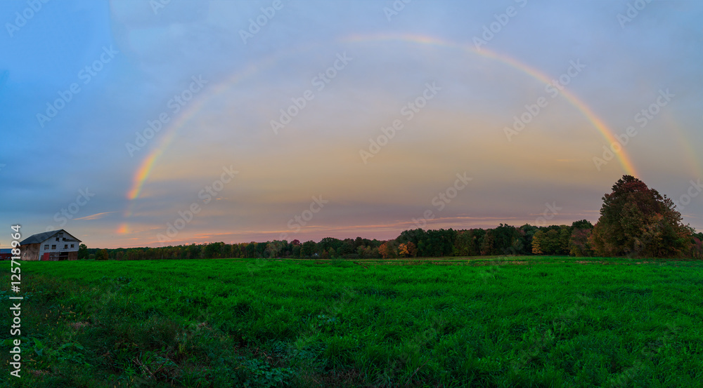 Naklejka premium Rainbow over autumn hillside in Berkshires Hudson Valley NY