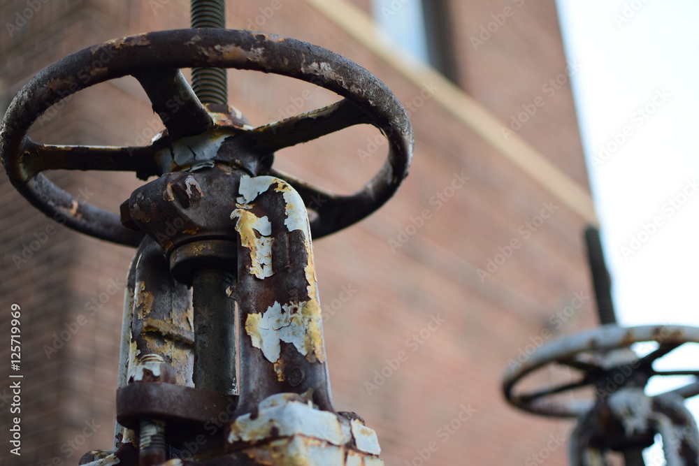 Rusty Pressure Release Valve with Brick Wall in Background Rusty Pressure Release Valve with Brick Wall in Background