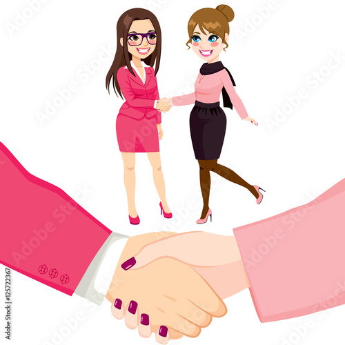 Young businesswomen people shaking hands on a successful agreement