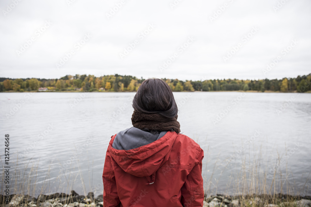 Back view of woman standing at seashore