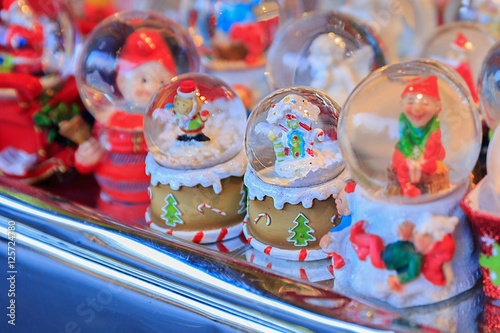 Colorful close up details of christmas fair market. Snowball decorations for sales © Adamsov studio