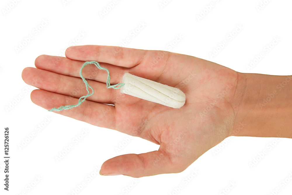 Female menstrual sanitary tampon in the palm. Isolate.