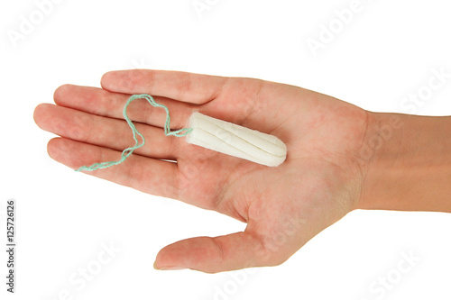 Female menstrual sanitary tampon in the palm. Isolate.