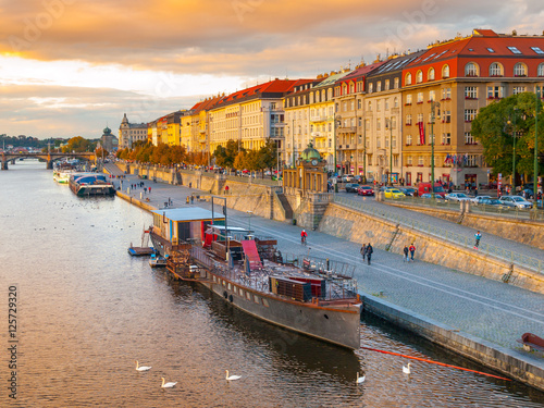 Canvas Print Evening view of Rasin Embankment with boats on Vltava River in Prague, Czech Rep