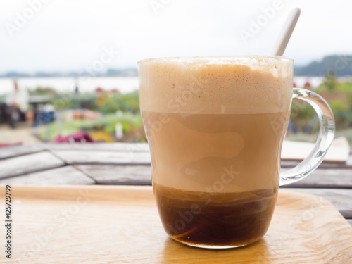 Hot caramel coffee latte on wood table at Kawaguchiko lake, Japan