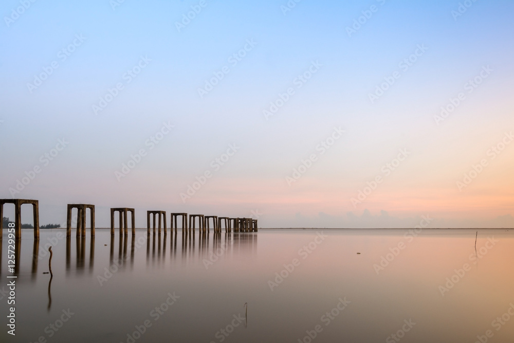 Old and abandoned pier with leftover column Old and abandoned pier with leftover column