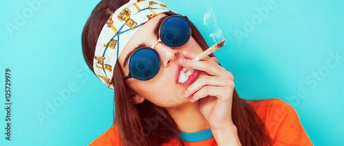 Hippy girl portrait smoking weed and wearing sunglasses letterbox