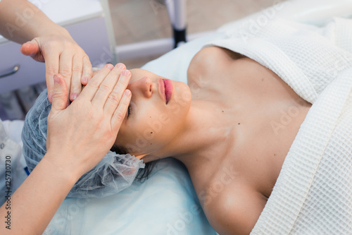 Smiling brunette enjoying a head massage in the health spa © romankosolapov