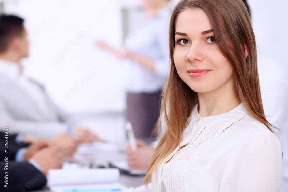 Portrait of a young business woman at meeting. Portrait of a young business woman at meeting.