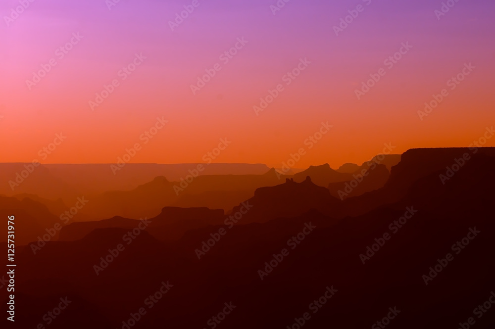 Panoramic View of Grand Canyon in red and purple colors after sunset