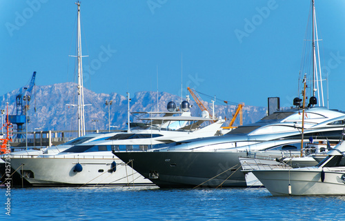 Many luxury yachts in the harbor.