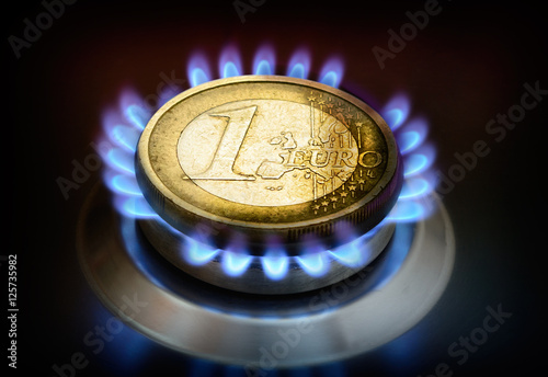 Cost of gas. Coin one euro on a gas torch.  photo