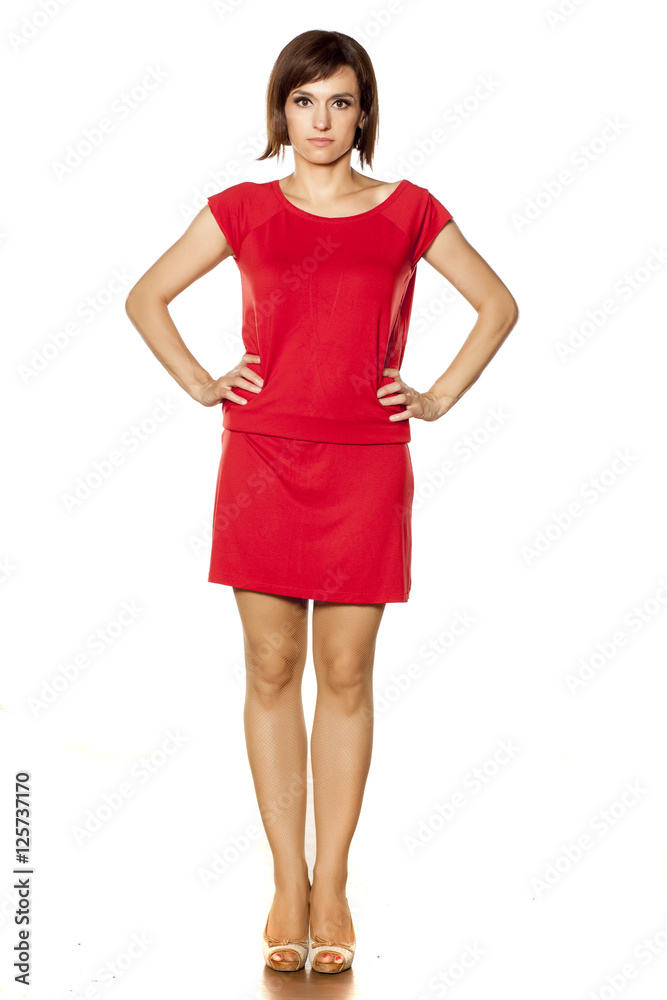 full figure of middle aged woman in short red dress. front view full figure of middle aged woman in short red dress. front view