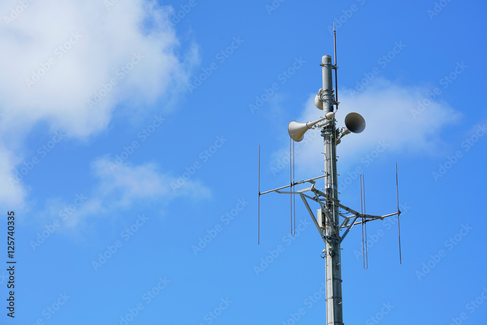 Radio pole and broadcasting when emergency situation with the blue sky background and copy space Radio pole and broadcasting when emergency situation with the blue sky background and copy space