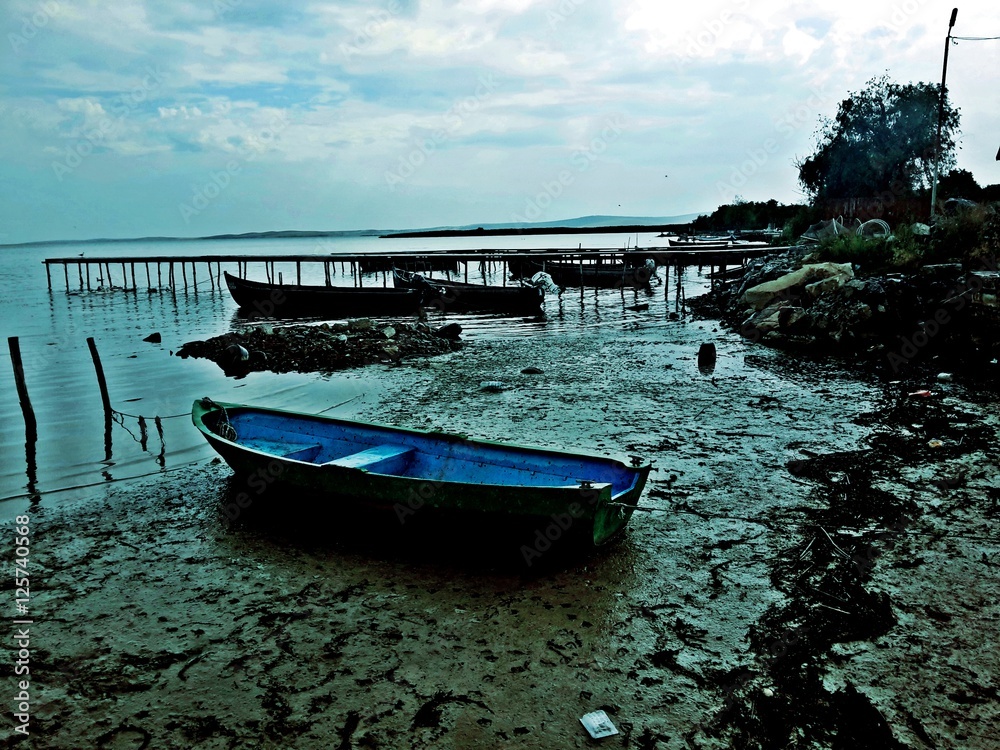 Boats at bay in a cloudy, stormy day