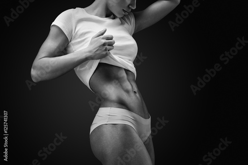 Close-up of muscular abdomen of female model
