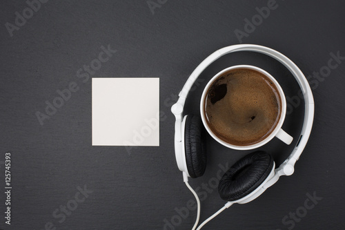 Photography Cup of coffee and white Headphones, top view. Black background