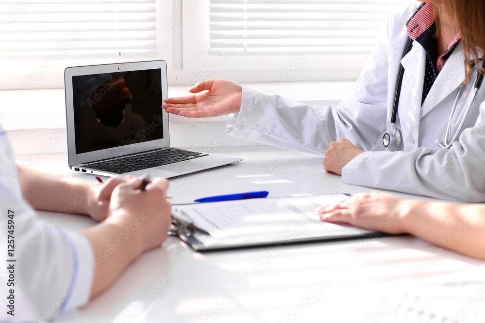 Fototapeta premium Doctor and patient are discussing something, just hands at the table
