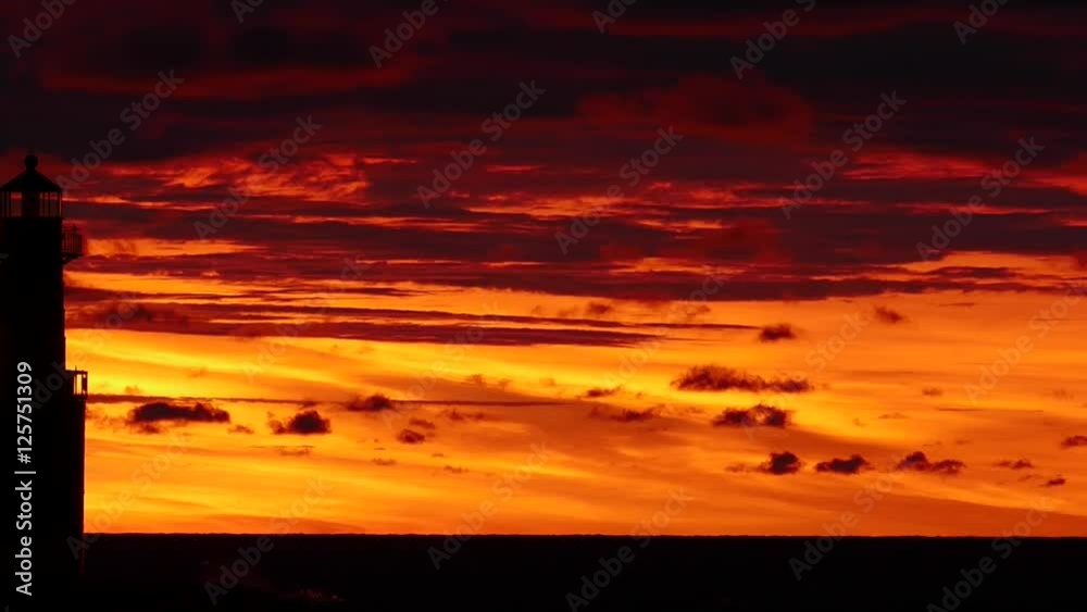 Amazing red sky predawn panning time lapse of Lake Michigan lighthouse.
