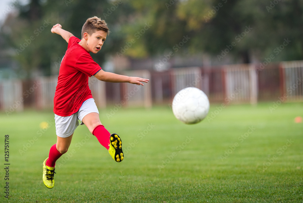 Naklejka premium Boy Shooting at Goal