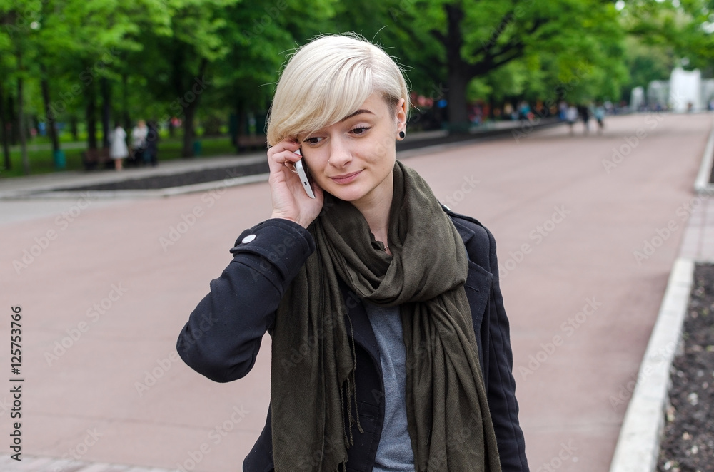 Fototapeta premium Young girl using her phone