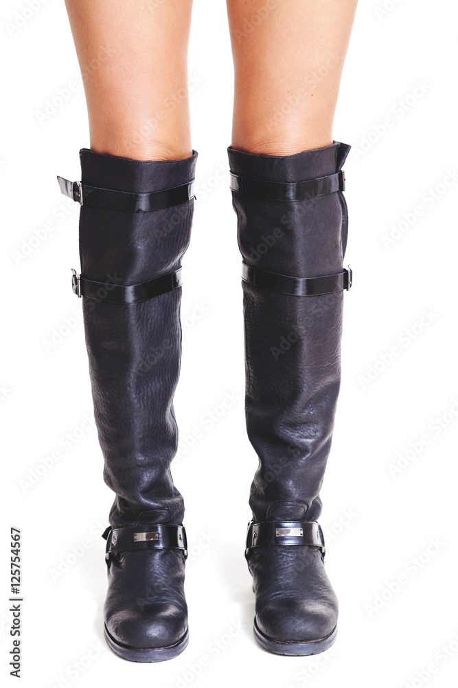 Shapely female legs in high leather boots front view Shapely female legs in high leather boots front view