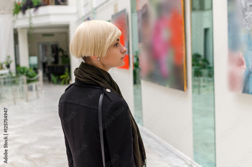 Young girl walking in the art gallery Young girl walking in the art gallery