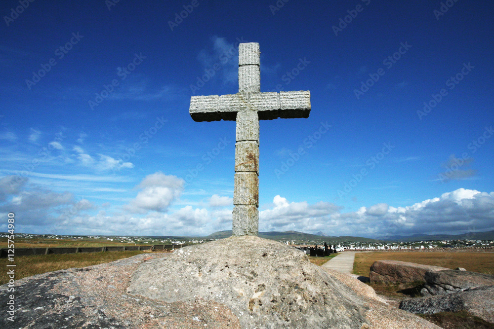 Large stone cross under a blue sky