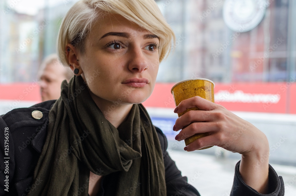 Young girl with a plastic cup of coffee