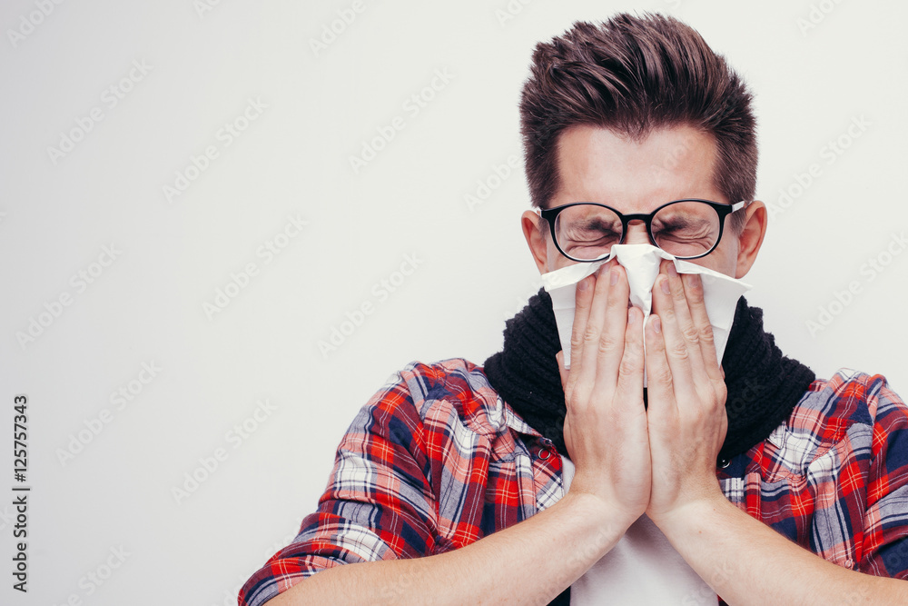 Attractive young man got a cold. All isolated on white background. Attractive young man got a cold. All isolated on white background.
