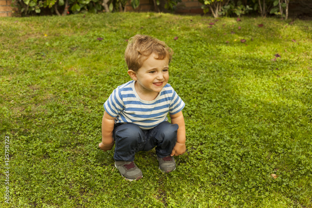 Full shot portrait cute baby boy in the grass Full shot portrait cute baby boy in the grass