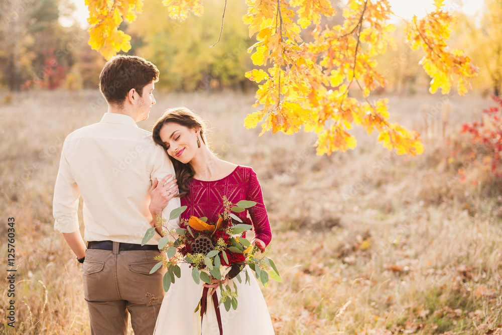 Stylish and romantic caucasian couple in the beautiful autumn park. Love,  relationships, romance, happiness concept. Bouquet in girl's hands. Stock  Photo | Adobe Stock